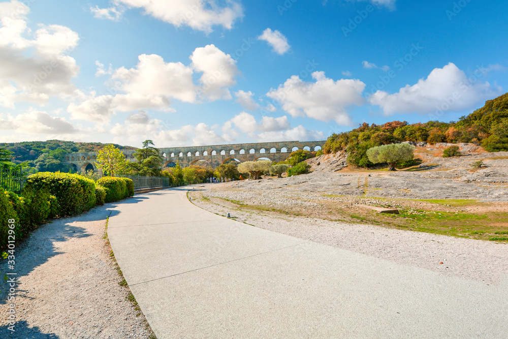 A path leads to the ancient Pont du Gard Roman Aqueduct over the River Gardon in the Provence area of Southern France.