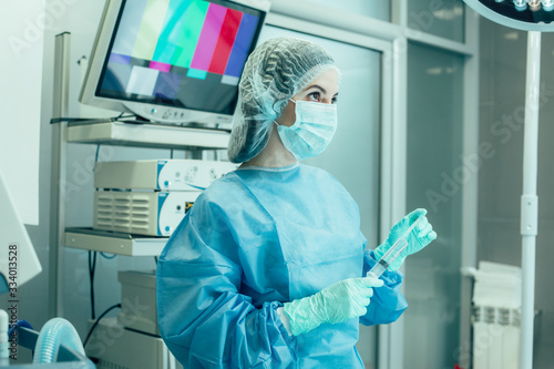 Female surgeon looking up at work stock photo
