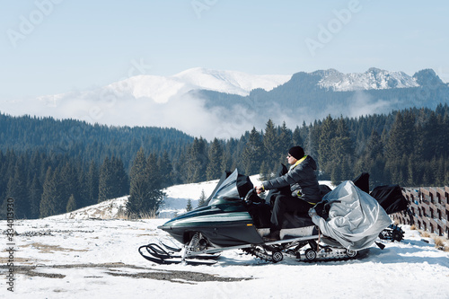 Man on snowmobile in mountains