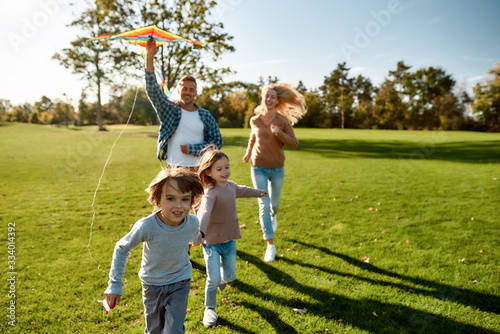 There are no words to describe how special kids are. Happy family playing a kite. Outdoor family weekend