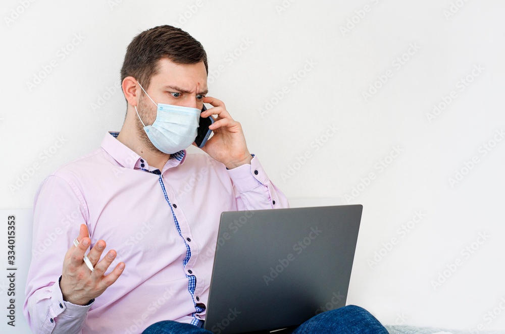 Coronavirus. Quarantine. A man in a shirt and jeans solves work issues remotely. Coronavirus. Quarantine. A man in a shirt and jeans solves work issues remotely.