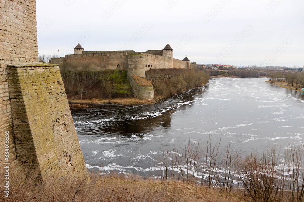 View to impregnable russian fortress Ivangorod from bastions of Narva Hermann castle with wall of the tower on the left