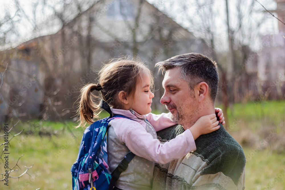 happy family and father's day. child daughter kissing and hugging dad happy family and father's day. child daughter kissing and hugging dad