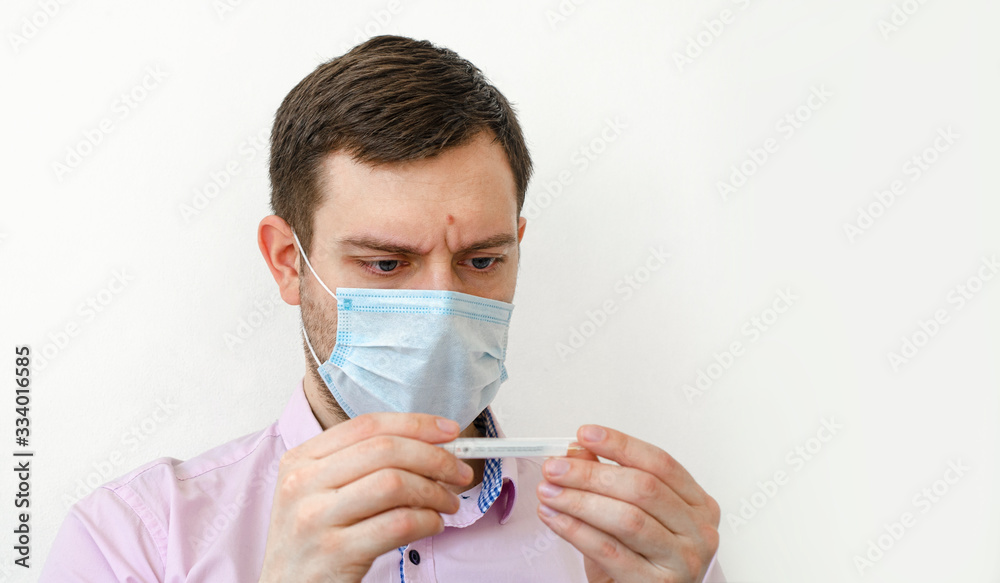 Coronavirus. Quarantine. A man in a shirt measures the temperature. High temperature. Coronavirus. Quarantine. A man in a shirt measures the temperature. High temperature.