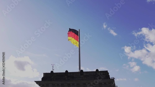 Flag of Germany on Reichstag Building. Famous Reichstag building and tourist place. Closeup and slow motion shot