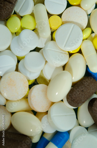 Multicolored pills texture. Pills closeup. Medicine theme texture. Health theme background. photo