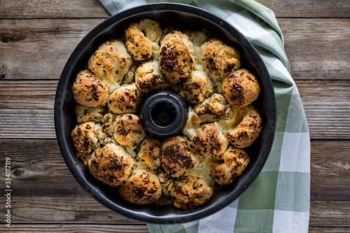 Photography Top down view of a bundt pan filled with freshly baked pull apart rolls ready for eating