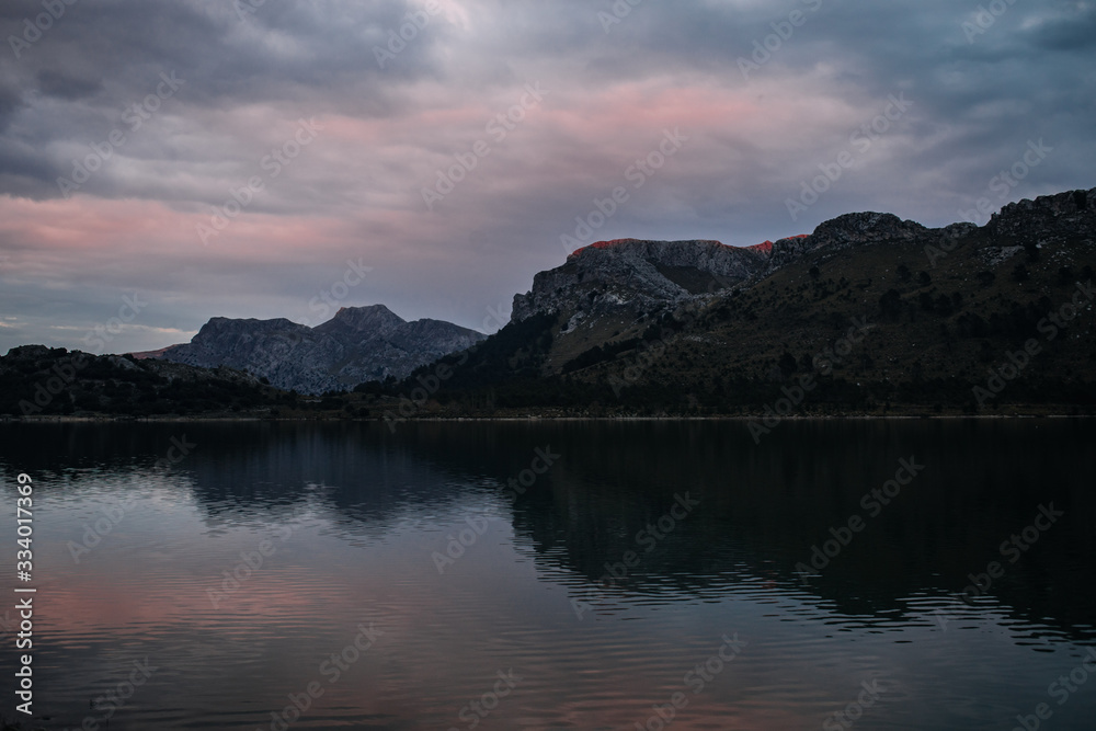 mountain lake in moody atmosphere after sunset