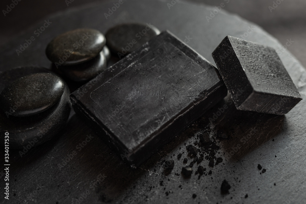 Black carbon charcoal soap on a black granit background Black carbon charcoal soap on a black granit background