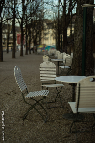 Empty tables of street cafe. Impact of lockdown, coronavirus quarantine © Lisa Bauer