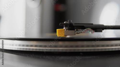 Old school record player. Close up vinyl record spinning. Needle playing record album on a vintage turntable. 