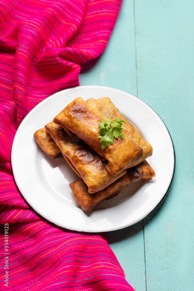 Mexican chimichanga on turquoise background