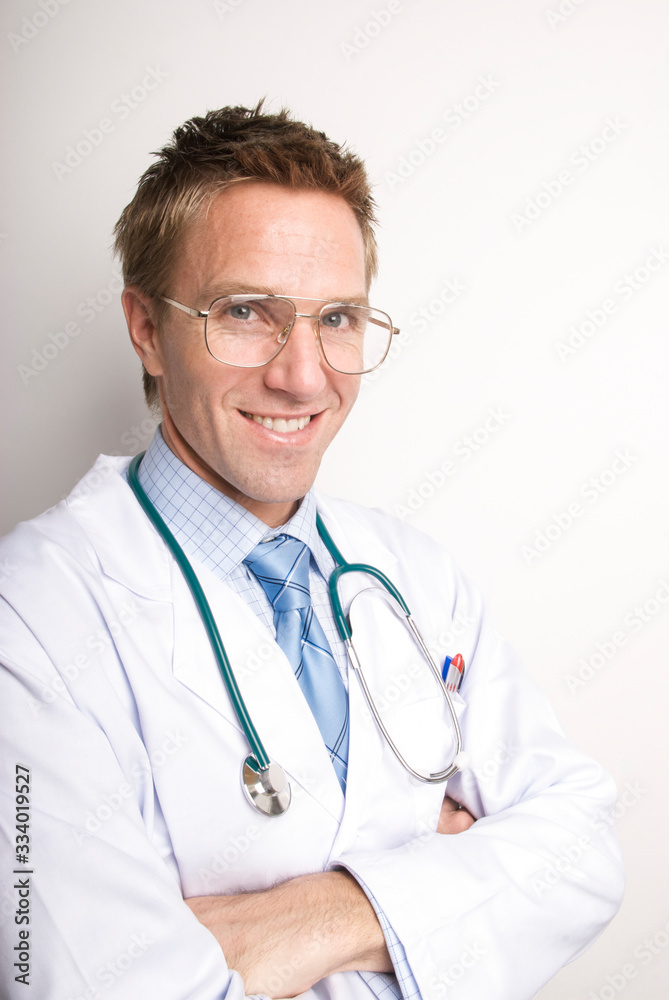 Portrait of smiling doctor in white lab coat and stethoscope with arms folded Portrait of smiling doctor in white lab coat and stethoscope with arms folded