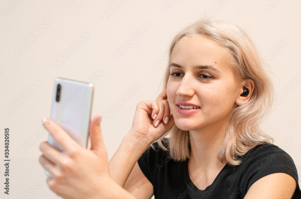 Girl communicates by video call. Wireless headphones. Modern technologies. Girl communicates by video call. Wireless headphones. Modern technologies.
