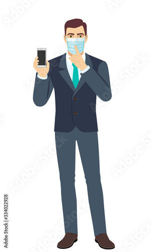 Hush hush. Businessman with medical mask holding mobile phone and shows hush-hush sign. Full length portrait of Businessman in a flat style.