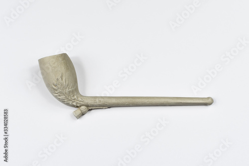 Traditional clay pipe shot side on against a white background.