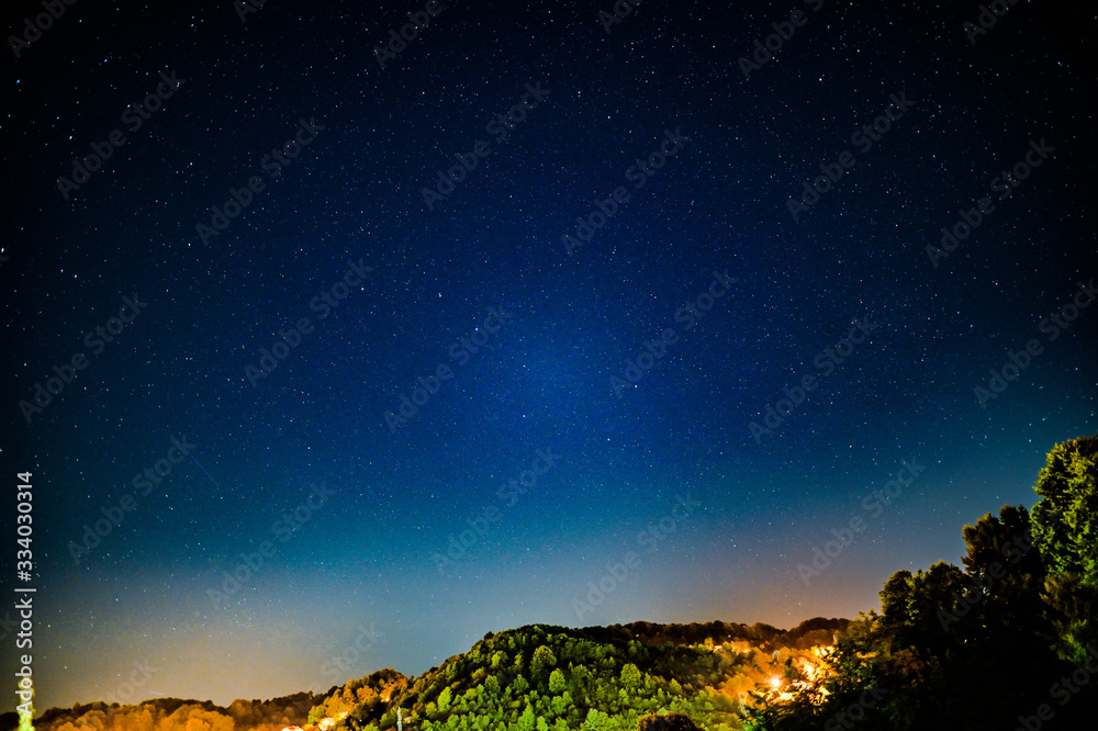 ight landscape with colorful Milky Way and yellow light at mountains. Starry sky with hills at summer. Beautiful Universe. Space background ight landscape with colorful Milky Way and yellow light at mountains. Starry sky with hills at summer. Beautiful Universe. Space background