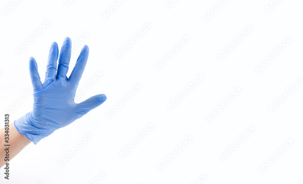 Hand in blue medical glove, five fingers, palm open hand. Medicine, hygiene, virus protection and COVID-19 coronavirus pandemic concept. Copy space. Place for your text Hand in blue medical glove, five fingers, palm open hand. Medicine, hygiene, virus protection and COVID-19 coronavirus pandemic concept. Copy space. Place for your text