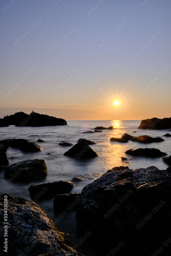 the sunset at the background in the atlantic ocean, Punta Ballena, Maldonado, Uruguay