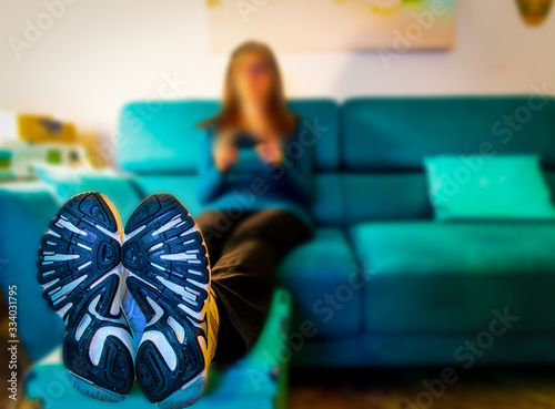 Close up of shoes of a woman sitting on the couch photo