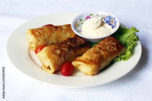 Pancakes with minced meat and sour cream, dishes of Russian national cuisine