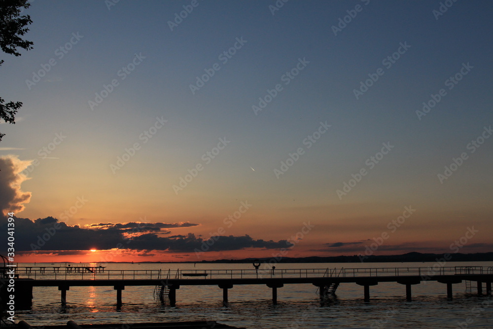 Fototapeta premium Sunset over Lake Constance (Bodensee) from the shore of Bregenz in Vorarlberg, Austria. 