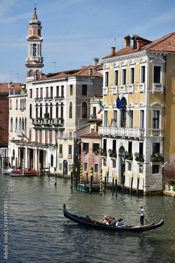 Venice canal with buildings on background and only one gondola on the water 