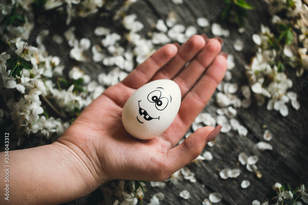 Egg on wooden background in human hands. Easter. Eggs. Bunny. Painted eggs. Holy day. People. Religion. Egg on wooden background in human hands. Easter. Eggs. Bunny. Painted eggs. Holy day. People. Religion.