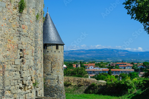 Picturesque walls of medieval  castle with metal roofs observing towers.