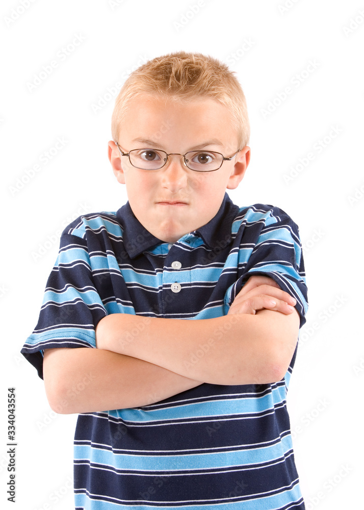 A blonde young boy wearing glasses with angry look, isolated on white. A blonde young boy wearing glasses with angry look, isolated on white.