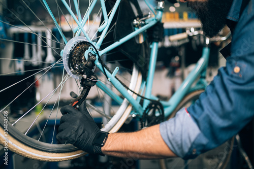 Close up of mechanic repairing bicycles in a workshop..