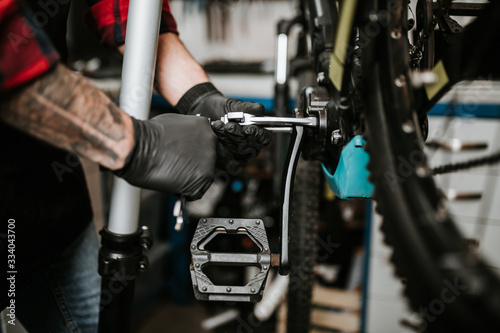 Close up of mechanic repairing bicycles in a workshop..