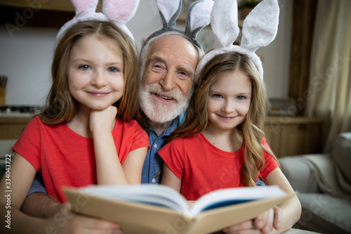 Positive family enjoying reading together stock photo