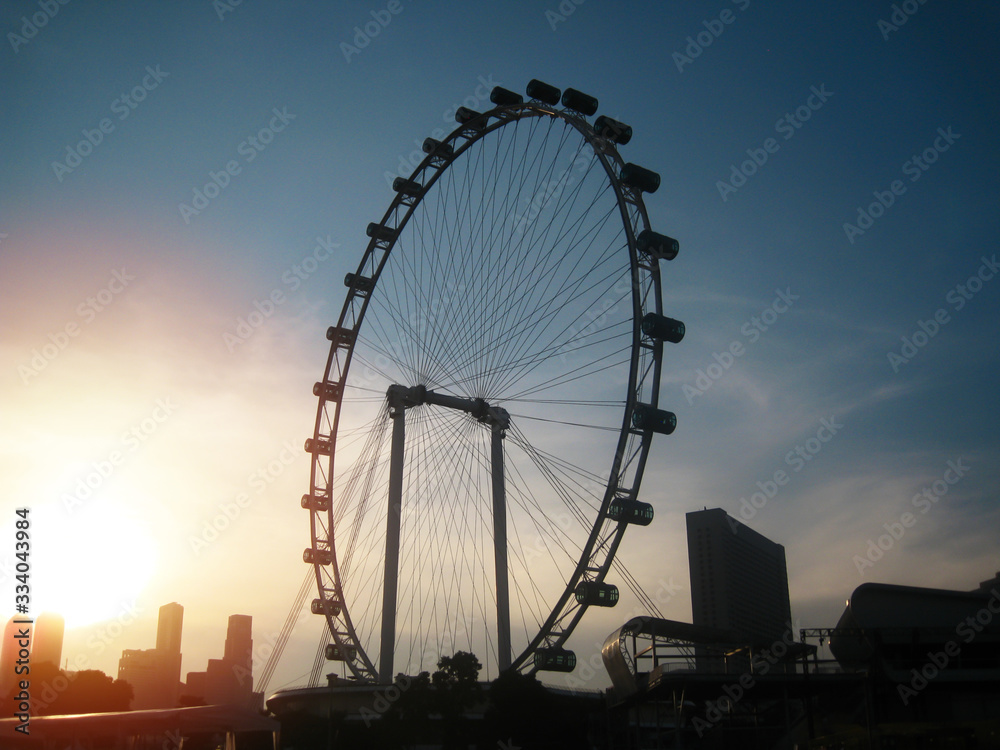 Big ferris wheel silhouette with beautiful sunset