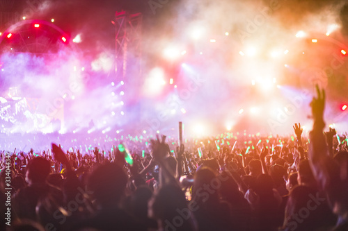 crowd with raised hands at concert festival