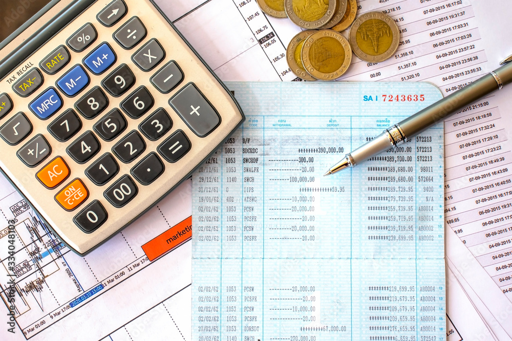 Pens and coins in the pockets on financial documents, financial concepts, tax calculations and financial status checking concepts. Pens and coins in the pockets on financial documents, financial concepts, tax calculations and financial status checking concepts.