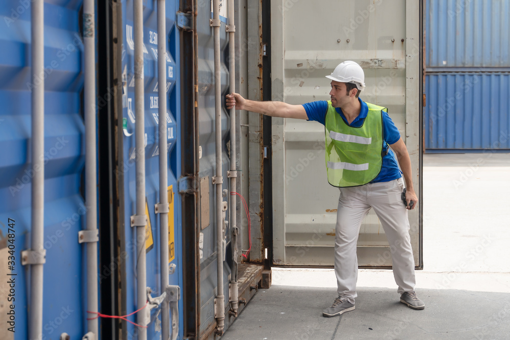 industrail background of caucasian containers yard and cargo inspector working at containers loading area industrail background of caucasian containers yard and cargo inspector working at containers loading area