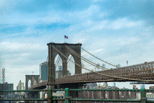 View of Lower Manhattan and Dumbo from the Brooklyn Bridge a cloudy day © eneko_at