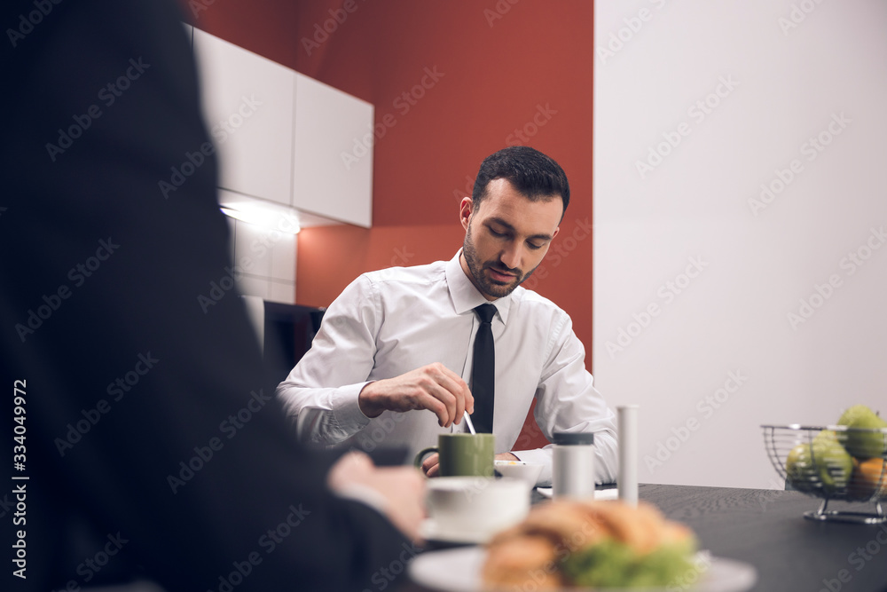 Caucasian young man drinking tea in office Caucasian young man drinking tea in office