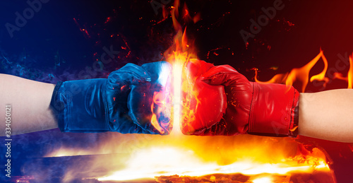 Fotografie Hands in boxing gloves punching.