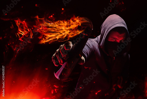 Protester holding burning molotov cocktail.