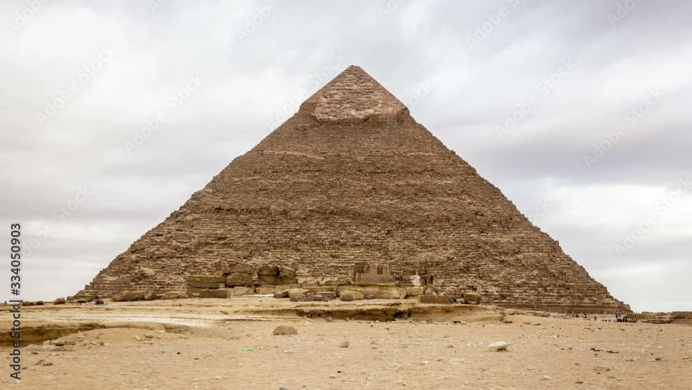 The Pyramid of Khafre (Chephren) located on the Giza Plateau in Cairo, Egypt. Clouds move fast across the blue sky. Time lapse video. The Pyramid of Khafre (Chephren) located on the Giza Plateau in Cairo, Egypt. Clouds move fast across the blue sky. Time lapse video.