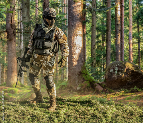 Soldier posing in forest.