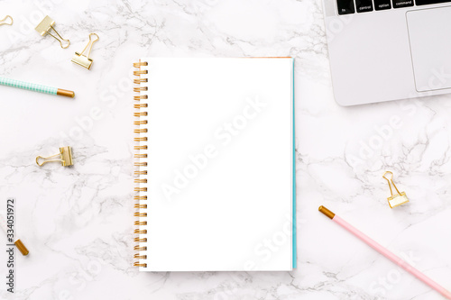 Festive golden stationary on white marble with Work from home wording. Feminine job, home office, distancing, social isolation, work from home and career concept. Isolated white copy space.