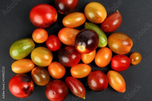 Obraz na plátně Fresh ripe mixed tomato verity assorted color on black background