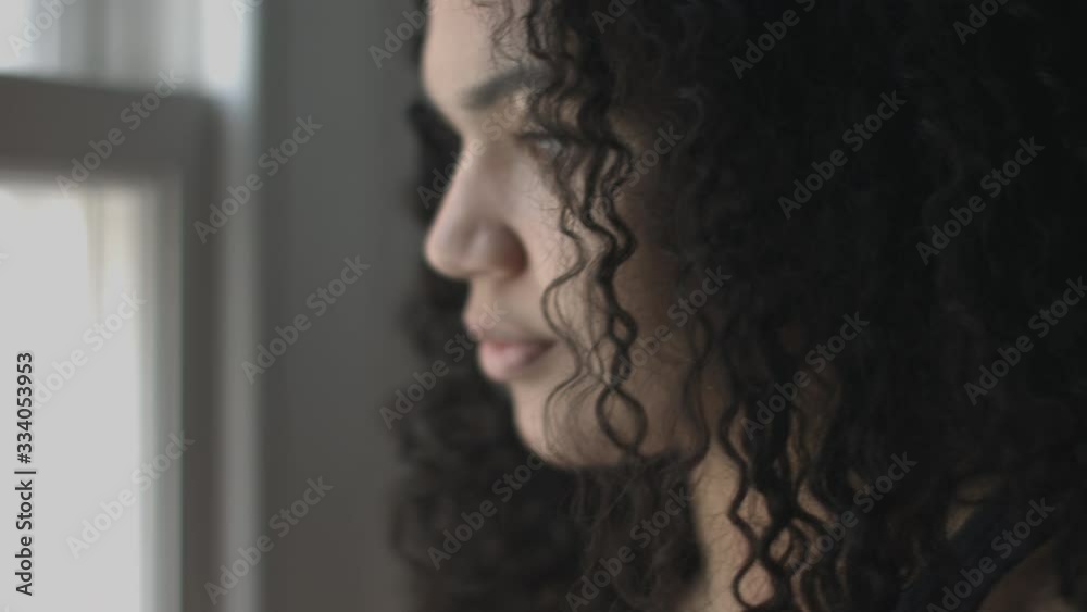 Pretty Mixed Race woman looking out of window
