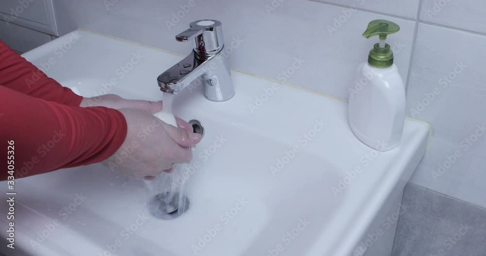 Man washing hands in bathroom at home. COVID-19 pandemic of 2020 Man washing hands in bathroom at home. COVID-19 pandemic of 2020