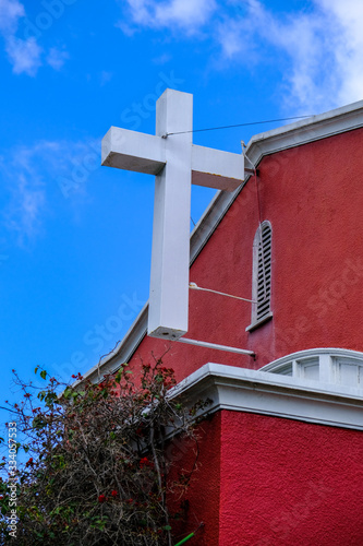 Red Church With Hanging White Cross, Blue Sky In The Background, Oakland, California
