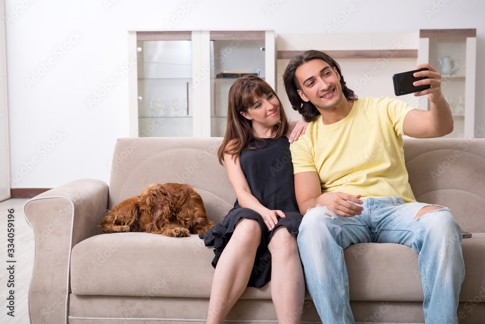 Young couple with cocker spaniel dog