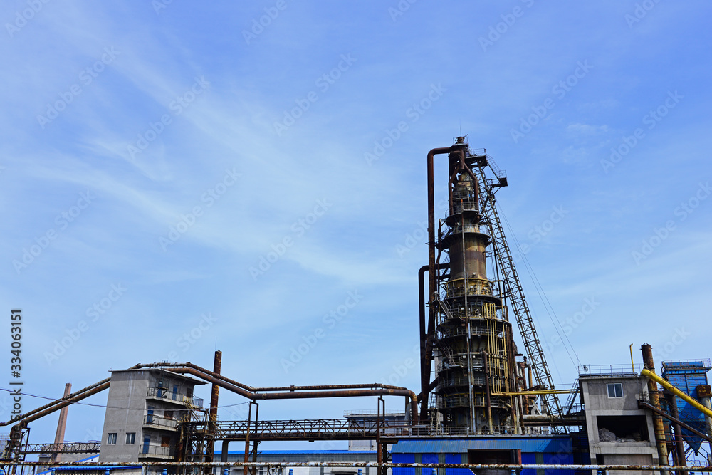 An old factory in the background of blue sky and white clouds